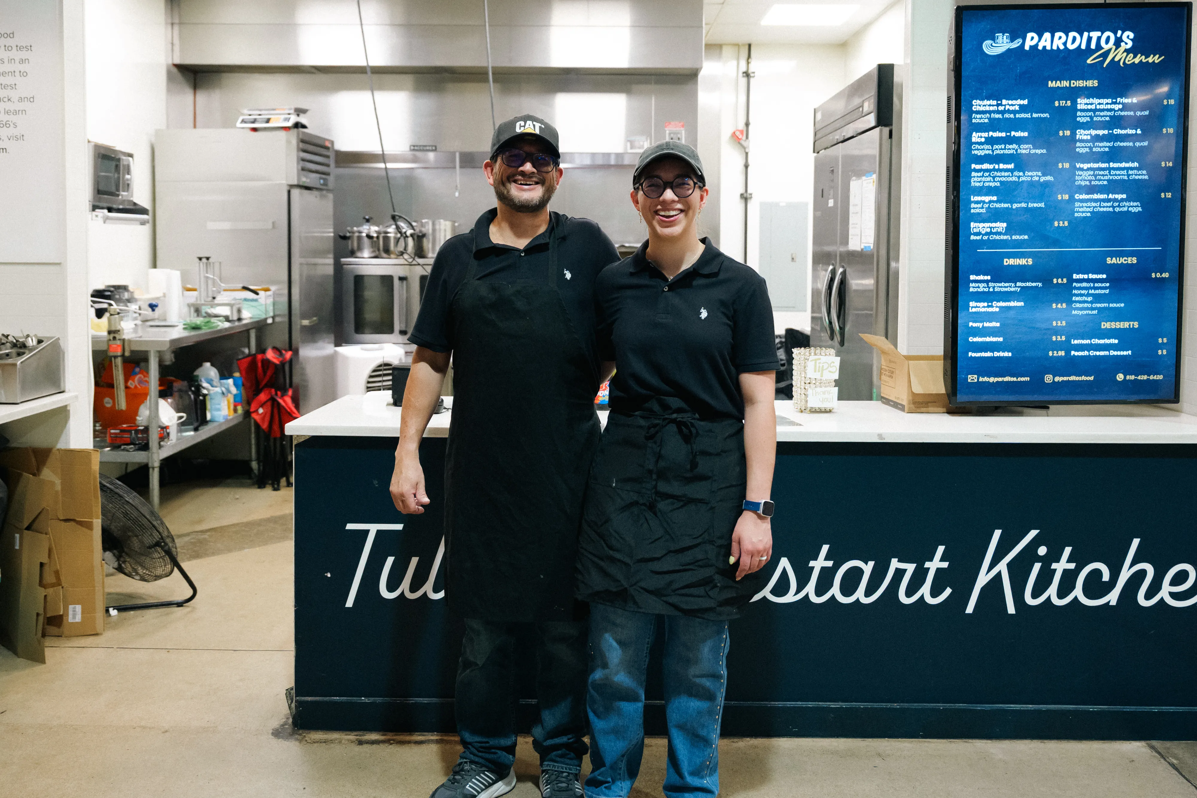 The two people behind Pardito's standing together in front of their kitchen counter